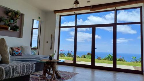 a living room with a large sliding glass door at Villa - Cantinho do Paraíso in Santo Espírito
