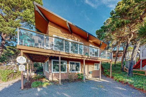 a house with a balcony on top of it at Arrow Point in Newport