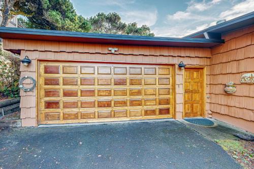 a garage with two wooden garage doors on a house at Arrow Point in Newport