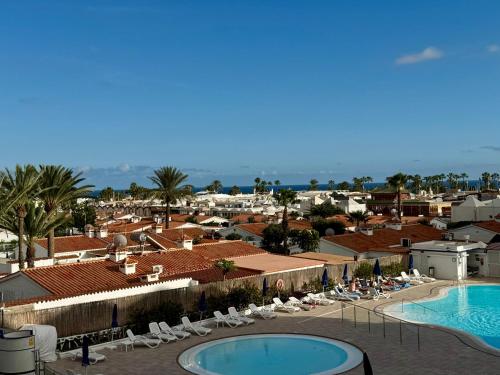 arial view of a resort with a pool and chairs at Tamarán 309 in Playa del Ingles