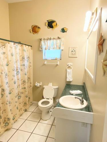 a bathroom with a toilet and a sink at Studio-Bay access-Pet friendly in Gulf Shores