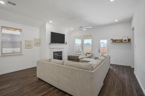 a living room with a couch and a fireplace at Southern Luxery Private Yard Tesla Plug BBQ Grill in Haslet