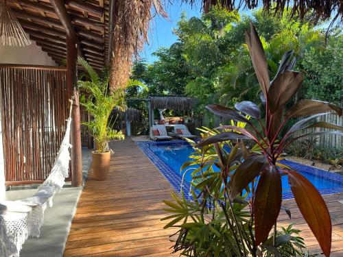 a wooden deck with a swimming pool in a backyard at VILA TRANCOSEAR in Trancoso