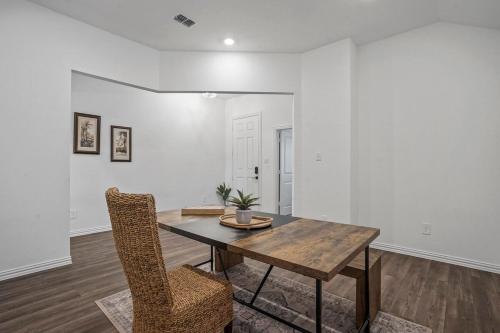 a dining room with a wooden table and chairs at Southern Luxery Private Yard Tesla Plug BBQ Grill in Haslet