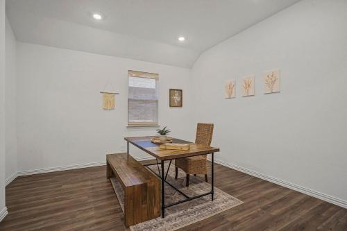 a dining room with a table and a table and chairs at Southern Luxery Private Yard Tesla Plug BBQ Grill in Haslet