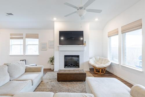 a living room with a fireplace and a flat screen tv at Southern Luxery Private Yard Tesla Plug BBQ Grill in Haslet