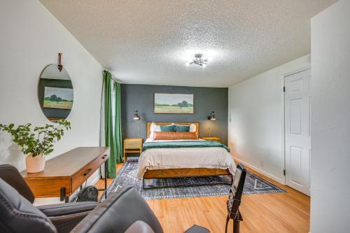 a bedroom with a bed and a desk at Jefferson City Bungalow Hot Tub and Patio! in Jefferson City