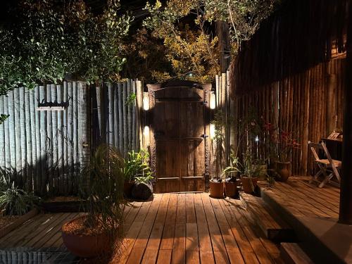 a patio with potted plants and a wooden fence at VILA TRANCOSEAR in Trancoso