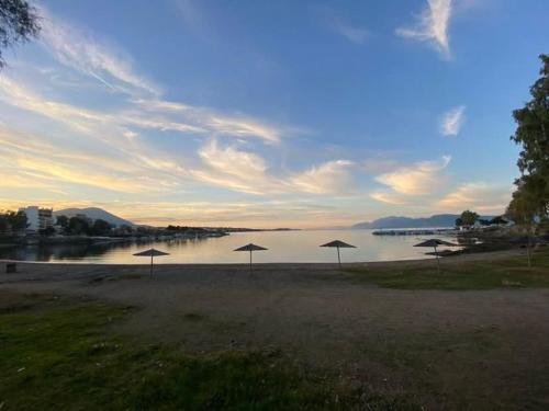 a group of umbrellas on a beach near the water at Bridge Art Studio Chalkida in Chalkida