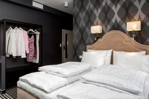 a bedroom with two beds with white pillows at Amber Suite Szczecin hotel na Starym Mieście Adults Only in Szczecin