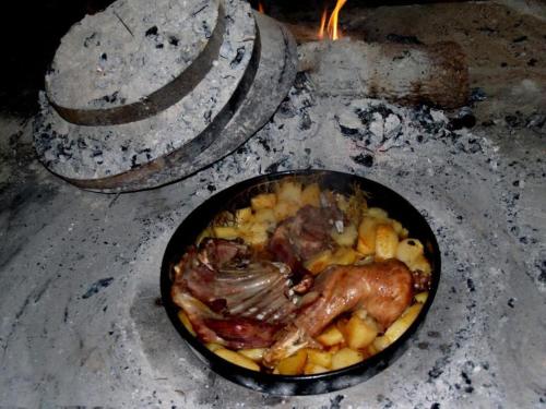 a pan filled with food in an oven at Rooms Marija in Trilj