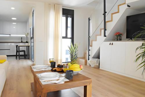 a living room with a table with fruit on it at Pepe Lux Ático centro de Málaga in Málaga