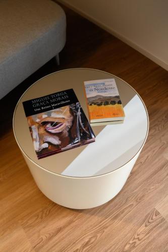 two books sitting on top of a table at BHB Boutique House in Macedo de Cavaleiros