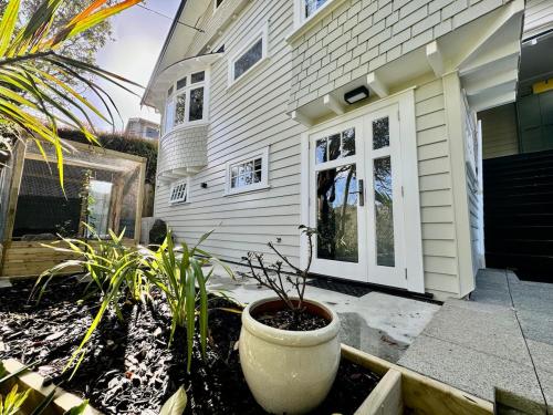 a house with a plant in front of a door at Studio on Hobson in Auckland