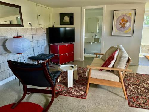 a living room with a couch and a tv at Studio on Hobson in Auckland