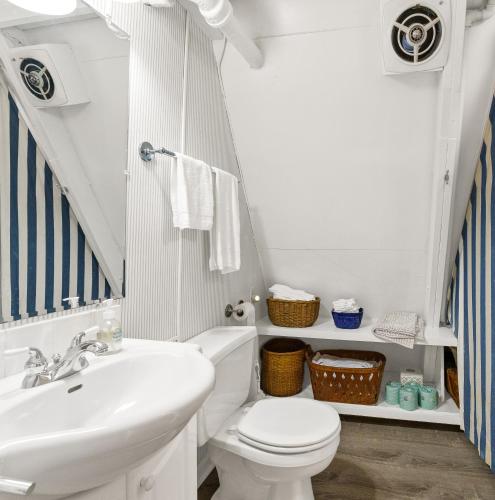 a bathroom with a white toilet and a sink at North Shore Private Beach Frontage in Spring Lake