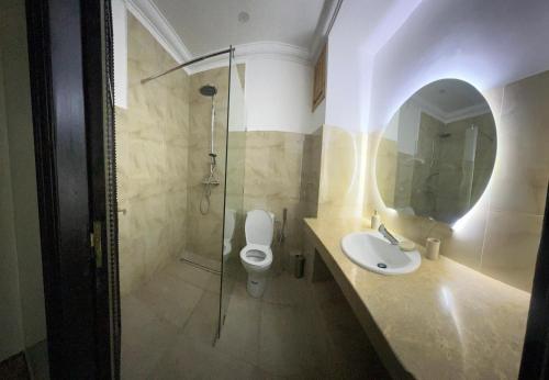 a bathroom with a toilet and a sink and a shower at Villa Marrakech piscine in Marrakech
