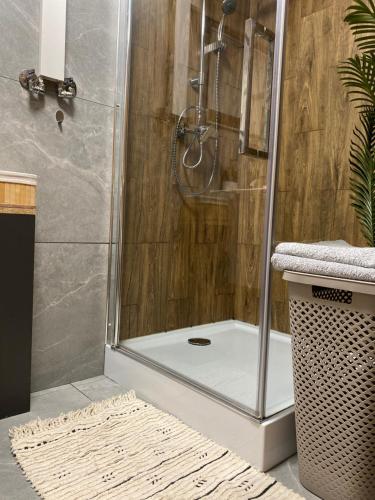 a bathroom with a shower with a glass door at Stodoła in Postomino