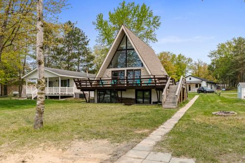 a large house with a gambrel roof at Loch Nez, a spacious 3-bedroom home in Silver Lake, MI in Mears