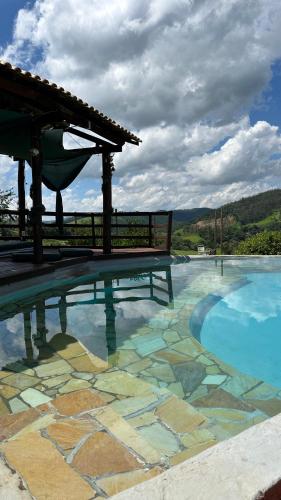 a swimming pool with a boat on top of it at Sítio Maranata Vale das Montanhas in Monte Alegre do Sul