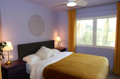 a bedroom with a large bed and a window at Villa Foia Vella - adults only in Benichembla