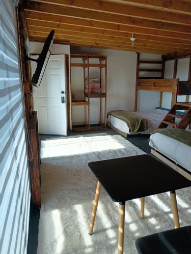 a room with two bunk beds and a table at casa rural el saltillo in Pemuco