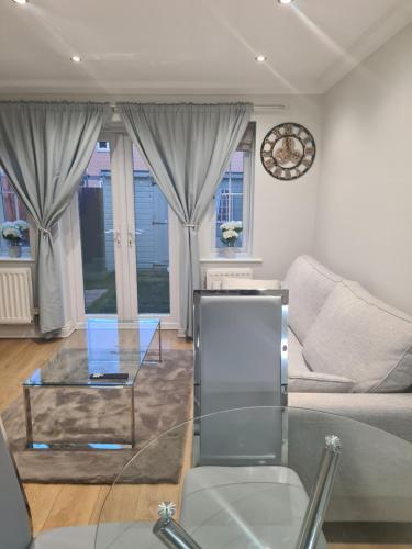 a living room with a couch and a glass table at Rays Lodge 2 in Middlesbrough