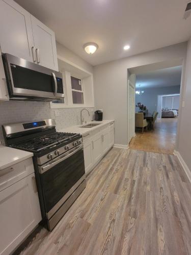 a large kitchen with a stove and a sink at Beautiful Big 3 bedroom Quiet Apt near downtown in Chicago