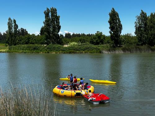 a group of people in a raft on a river at La Sirca Boutique Winery Cabins in Población