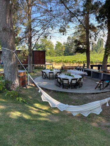 a picnic area with tables and benches in a park at La Sirca Boutique Winery Cabins in Población