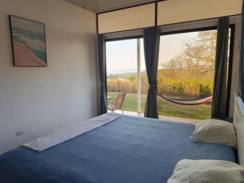 a bedroom with a bed and a large window at Pronájem prázdninového domu in Tivives