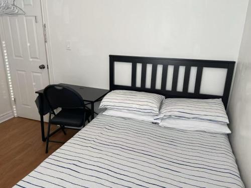 a bedroom with a bed with a chair and a desk at Double Room with SHARED Bathroom 536B in Toronto