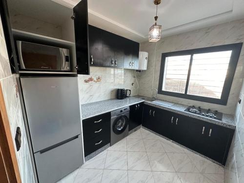 a kitchen with a refrigerator and a dishwasher at Charming Spacious Gem Near Fes Medina in Fès