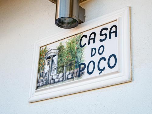 a sign on the side of a building on a wall at Casa do Poço - Serra da Estrela in Seia