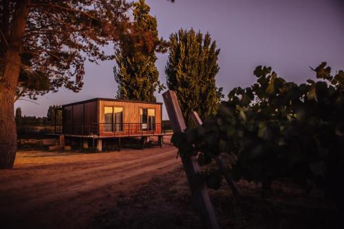 a house with a window on a dirt road at La Sirca Boutique Winery Cabins in Población
