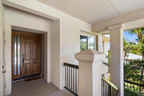 a house entrance with a wooden door and a porch at J3 Kumulani in Hapuna Beach