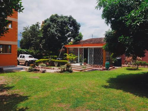 a house with a green lawn in front of it at Pearl Rangers Inn in Mbale