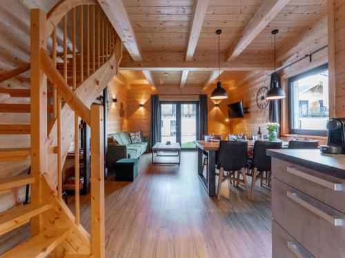 a kitchen and living room with a wooden ceiling at Rattendorf 21A in Rattendorf