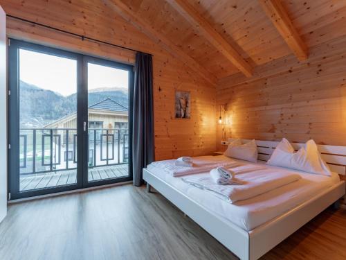 a bedroom with a bed and a large window at Rattendorf 21A in Rattendorf
