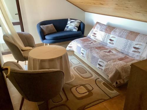 a living room with a bed and a chair and a table at Apartments by the sea Zavalatica, Korcula - 9137 in Zavalatica