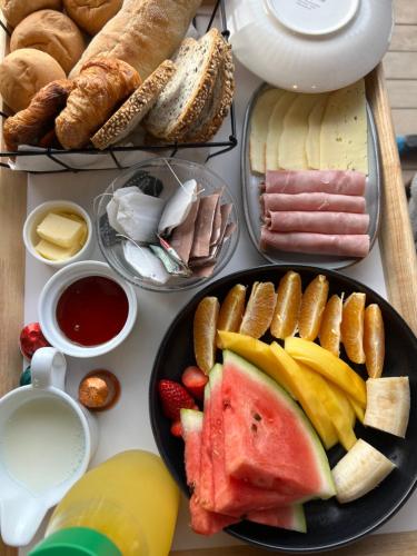 a table with a plate of different types of food at La Sirca Boutique Winery Cabins in Población
