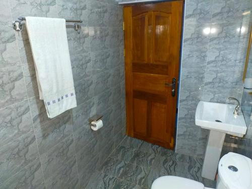 a bathroom with a toilet and a sink at Pearl Rangers Inn in Mbale