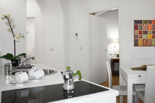 a kitchen with a sink and a counter top at Roma Resort Colosseum in Rome