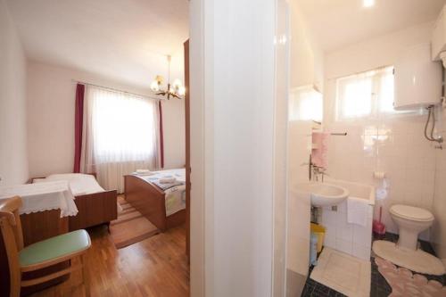 a bathroom with a sink and a toilet and a sink at Two Bedroom Apartment with Terrace A1 in Splitska