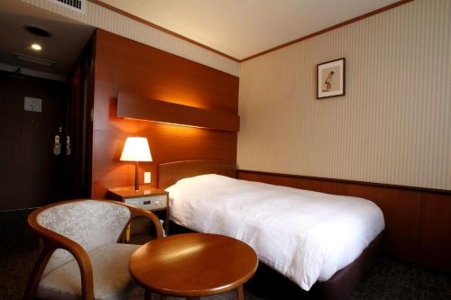 מיטה או מיטות בחדר ב-Daiichi Inn Park