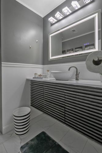 a bathroom with a sink and a mirror at Ellis Hideaway in Fayetteville