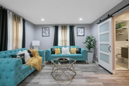 a living room with a blue couch and a table at Ellis Hideaway in Fayetteville