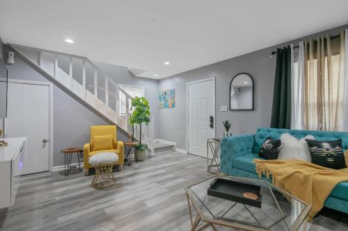 a living room with a blue couch and a staircase at Ellis Hideaway in Fayetteville