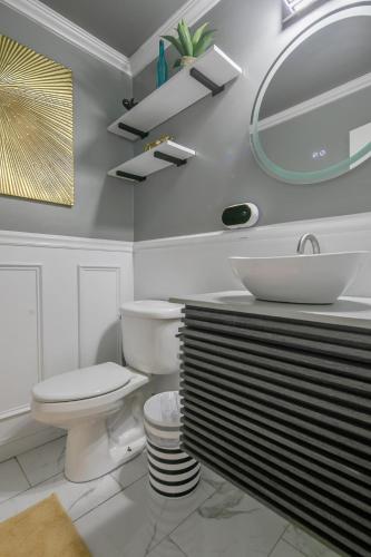 a white bathroom with a toilet and a sink at Ellis Hideaway in Fayetteville