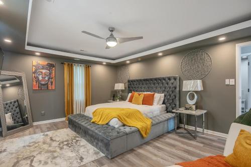 a bedroom with a large bed with a yellow blanket on it at Ellis Hideaway in Fayetteville